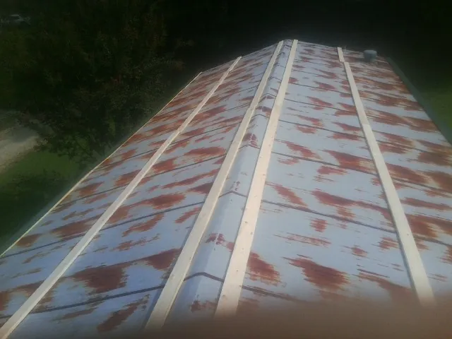 Rusted metal roof panels with new wood purlins before replacement — Storm Damage Roof Repair in Burlingham by Roofing Brothers