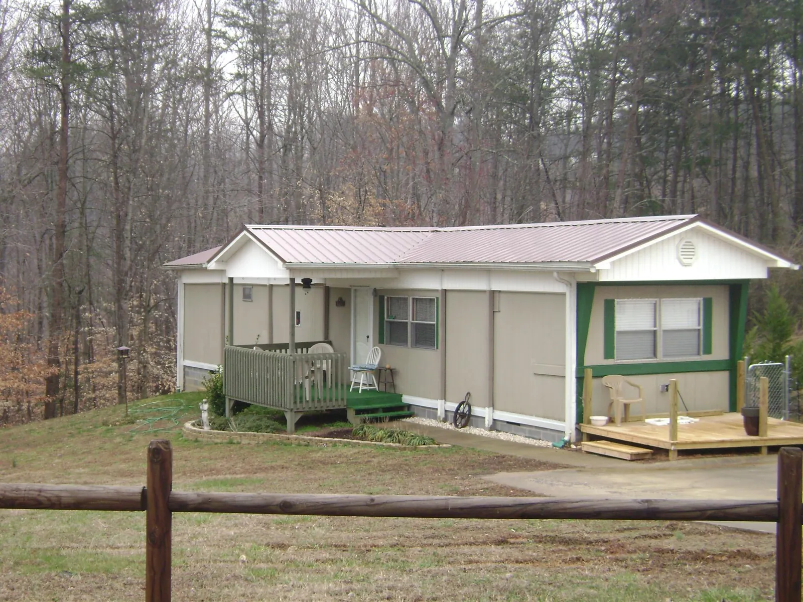 Mauve metal roof on a manufactured home with a new front deck in Burlingham